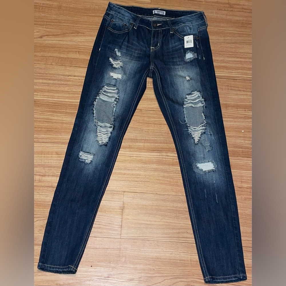 Photos with & without flash. Dark Soundgirl ripped jeans size 9. NWT attached.